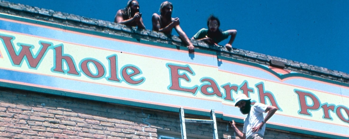 A group of OG Whole Earthlings construct the company's first official storefront signage..
